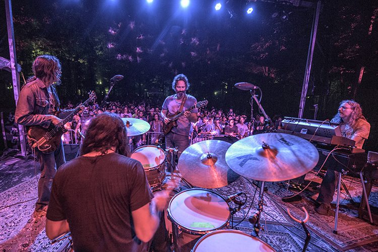 Band performing live on an outdoor stage.