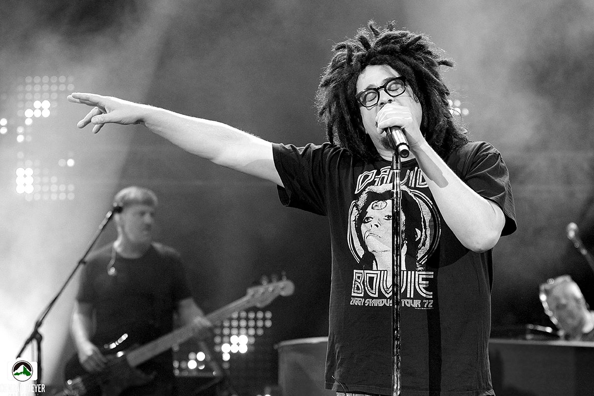 Singer performing on stage with microphone.