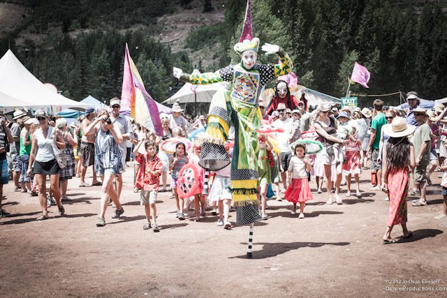 Festival crowd with person on stilts.