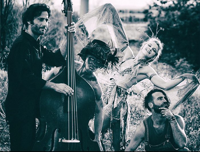 People posing creatively with musical instruments outdoors.
