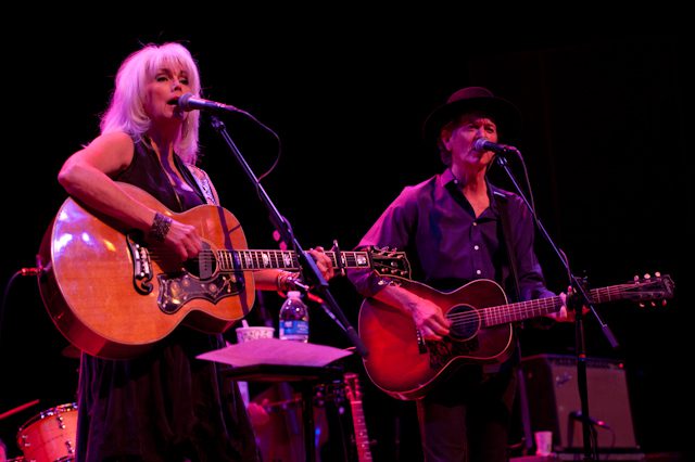 Two musicians performing on stage with guitars.