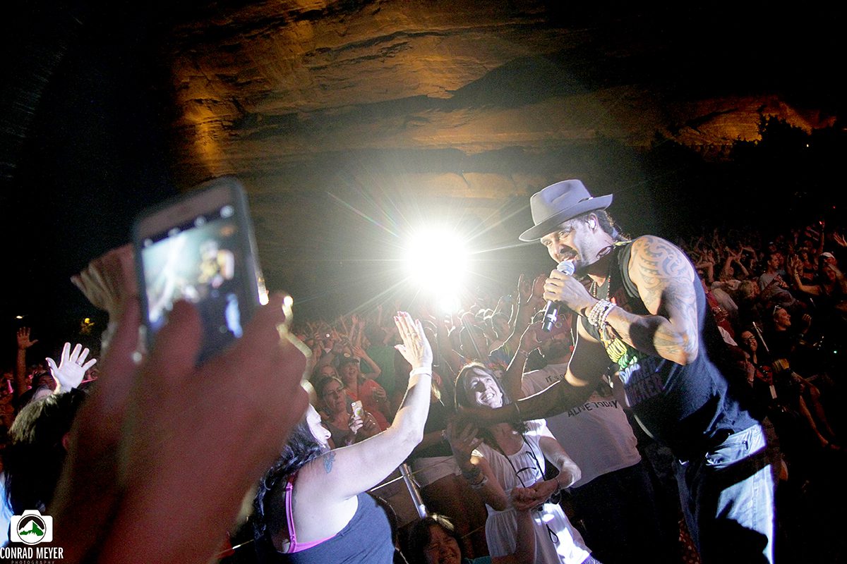 Performer engaging with audience at concert.