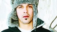 Man wearing a fur hat, neutral expression.