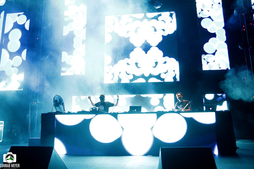DJ performance with vibrant stage visuals.