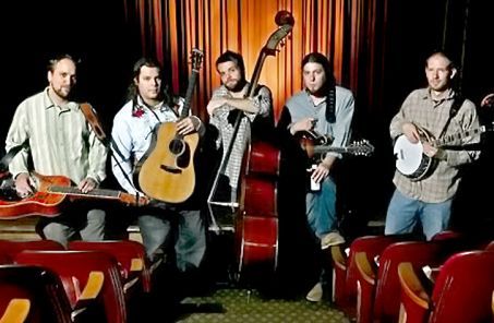 Band with instruments in a theater setting.