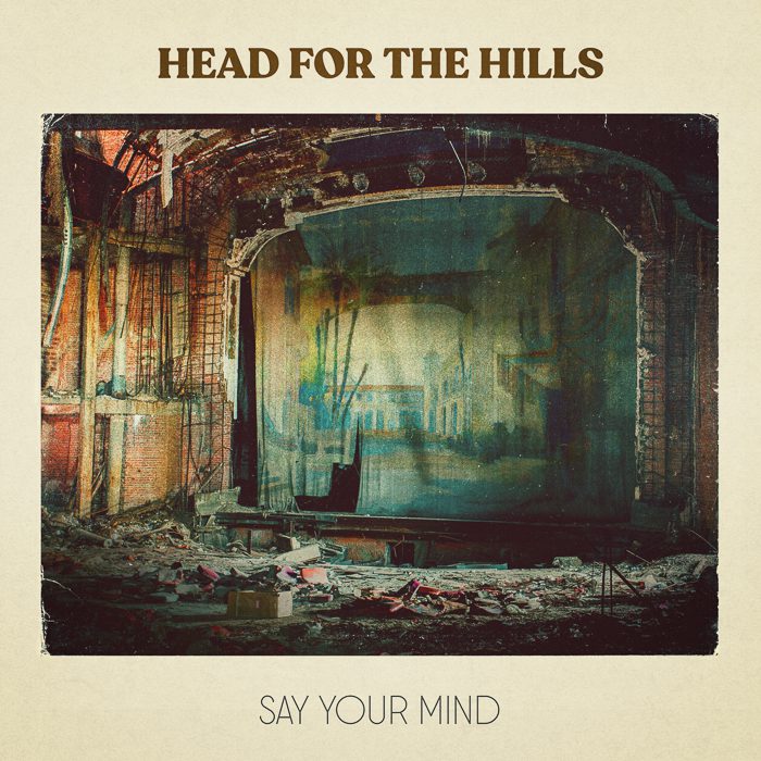 Ruined theater with "Head for the Hills.