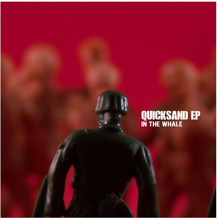 Toy soldier facing blurred figures, red background.