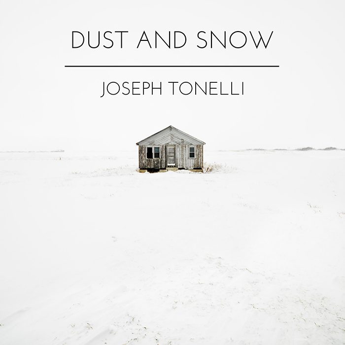 Small house in snowy landscape, minimalist design.