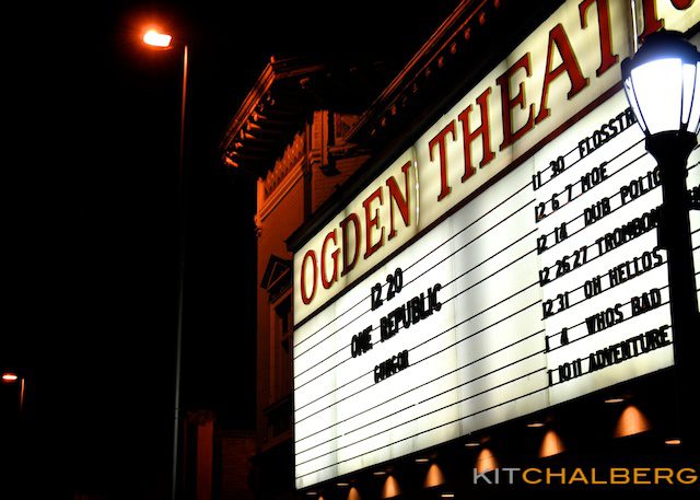 Ogden Theatre marquee at night with listings.