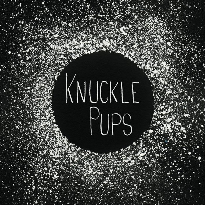 Knuckle Pups logo on splattered black background.