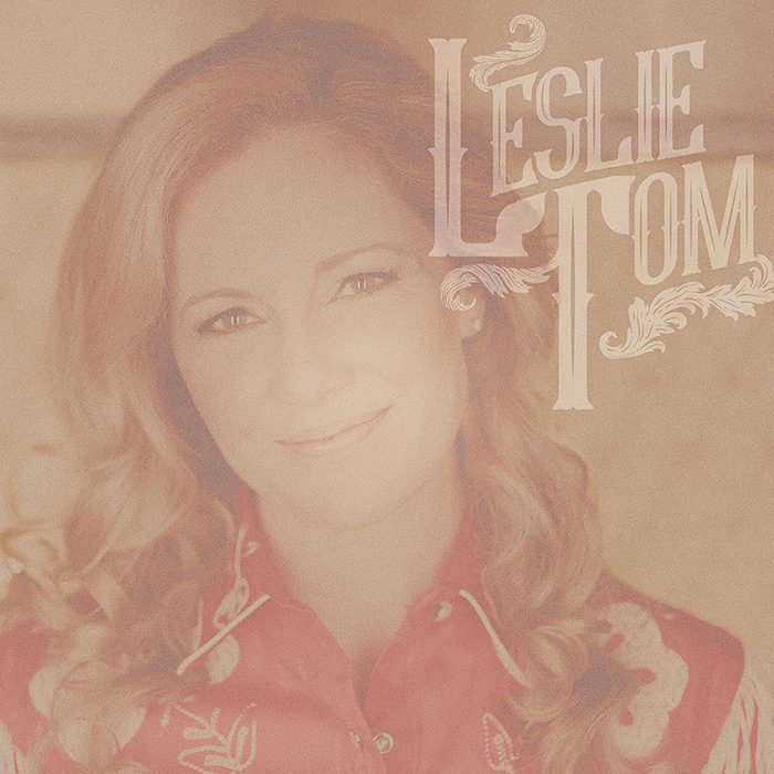 Woman smiling with "Leslie Tom" text overlay.