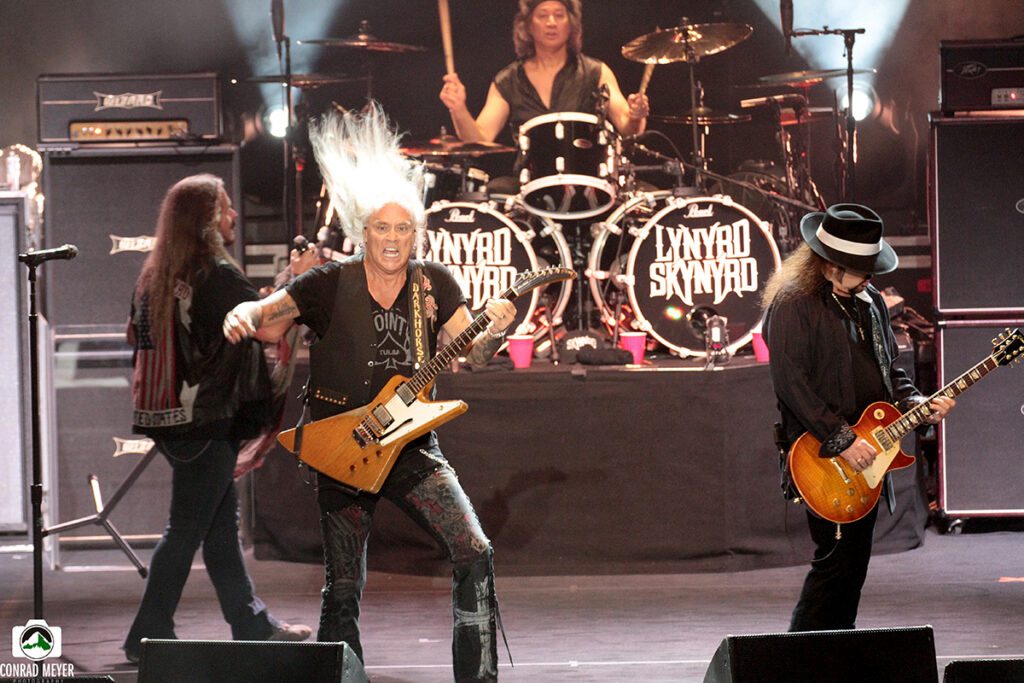 Band performing live on stage with guitars.
