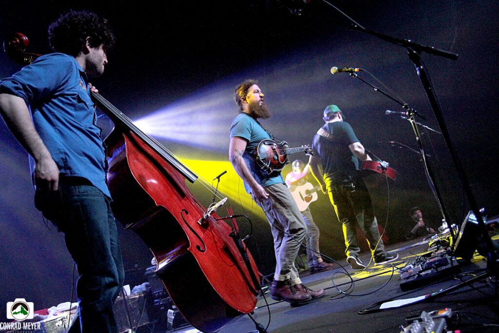 Band performing on stage with instruments.