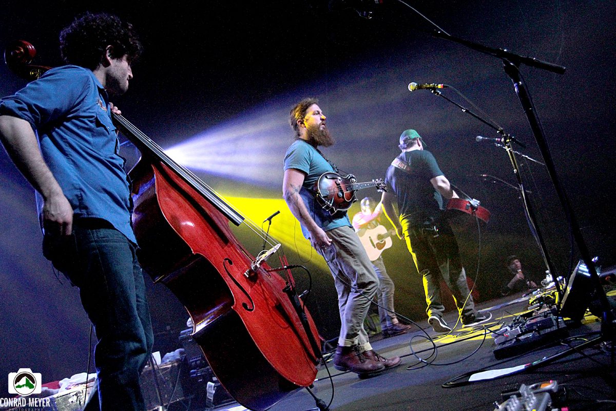 Band performing on stage with instruments.