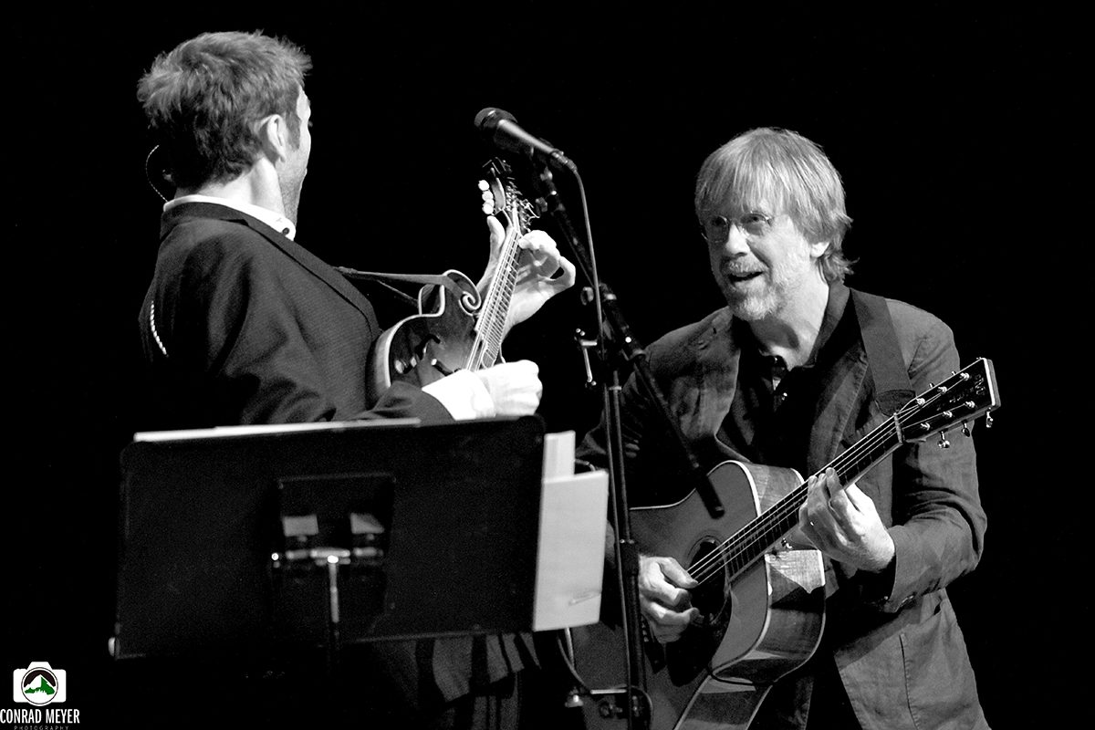 Two musicians performing on stage with guitars.