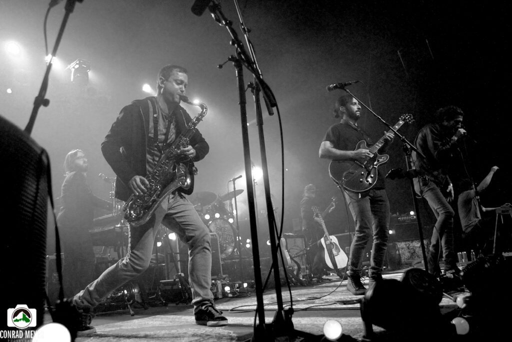 Band performing live on stage, black-and-white.