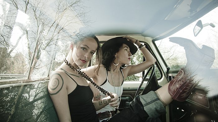 Two women sitting in a car.