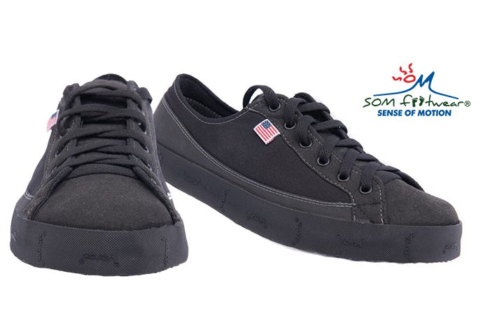 Black casual shoes with American flag logo.