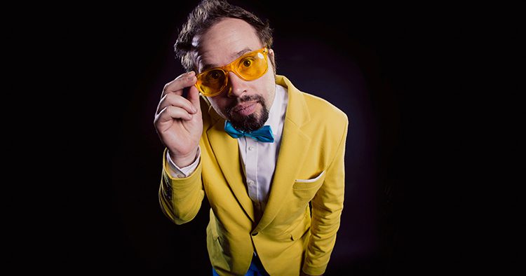 Man in yellow suit with orange glasses.