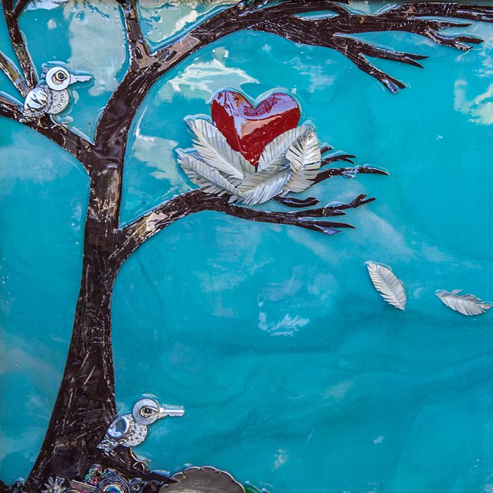 Tree with birds and heart-shaped nest.