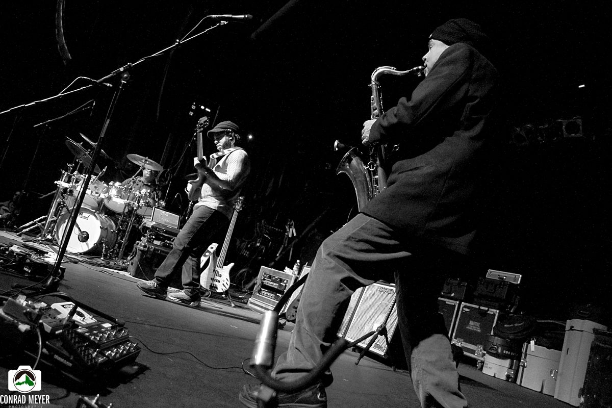 Band performing on stage with saxophonist.