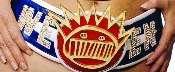 Person wearing Ween-themed belt with emblem.