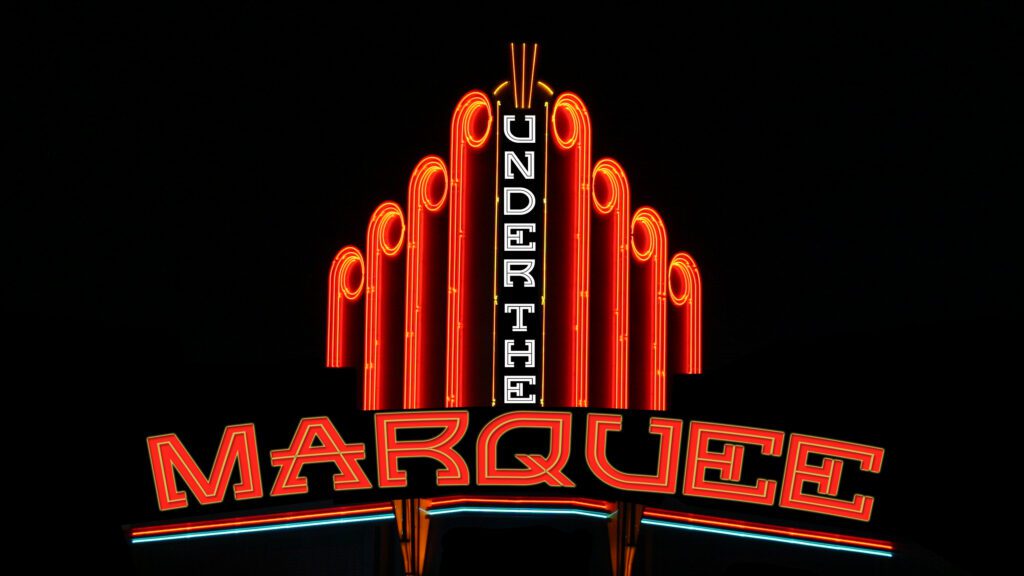 Neon sign reading "Under the Marquee".