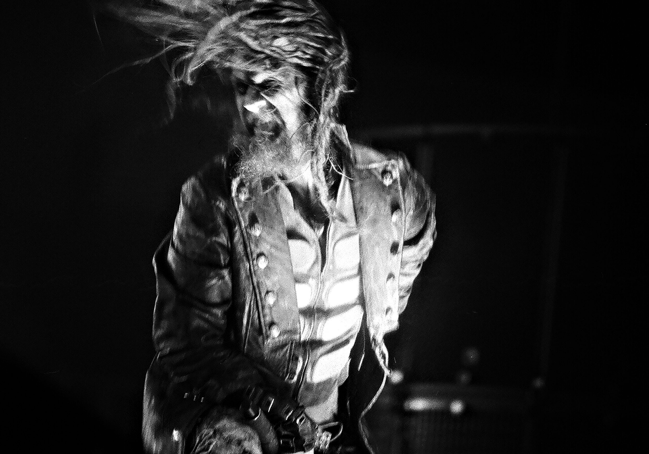 Performer on stage with dynamic hair movement.