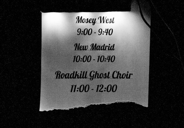 Concert schedule displayed on a lit sign.