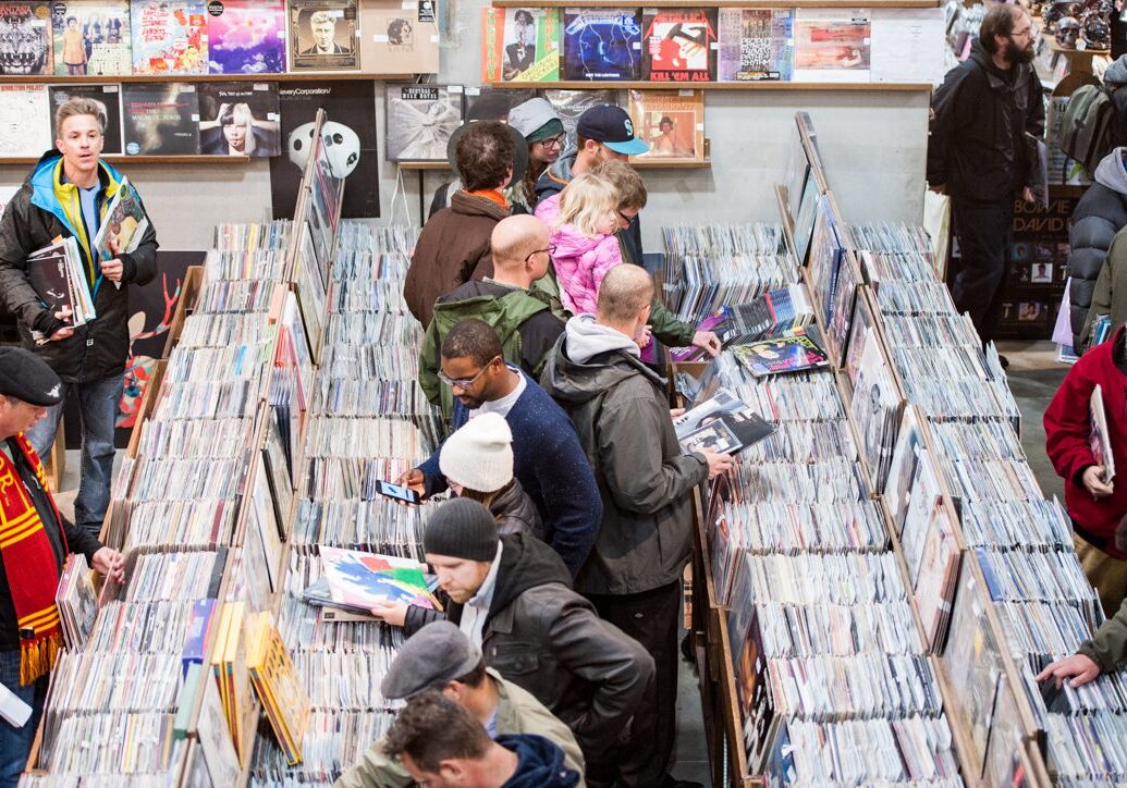 People browsing records in a busy store.