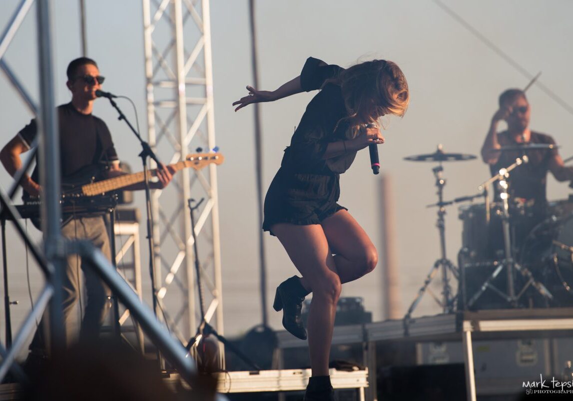 Band performing energetically on outdoor stage.