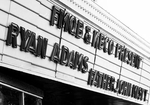 Theater marquee with concert announcement sign.