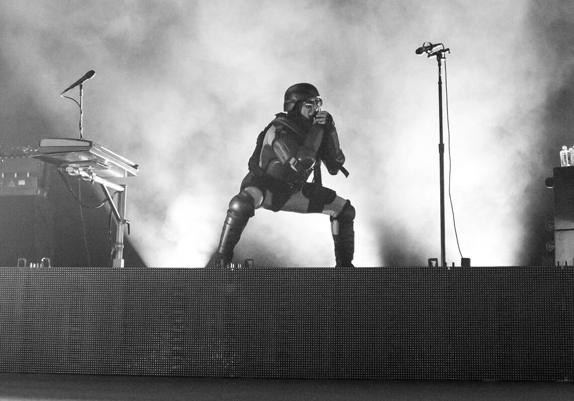 Performer in costume on stage with microphone.