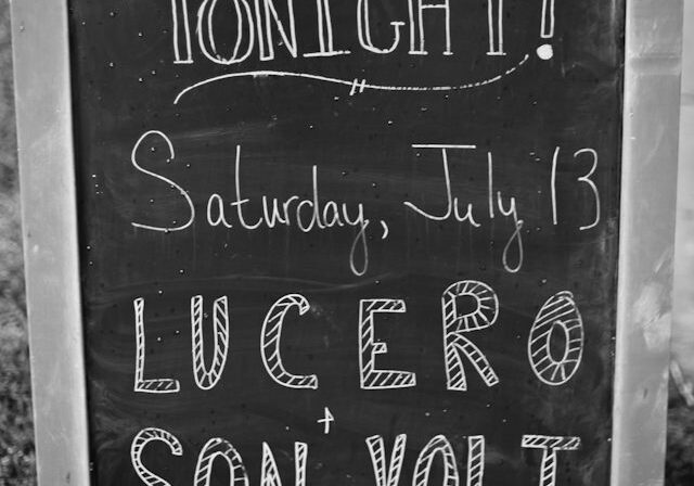 Chalkboard advertising concert event and ticket prices.