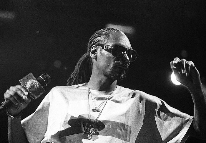 Artist performing on stage with microphone.