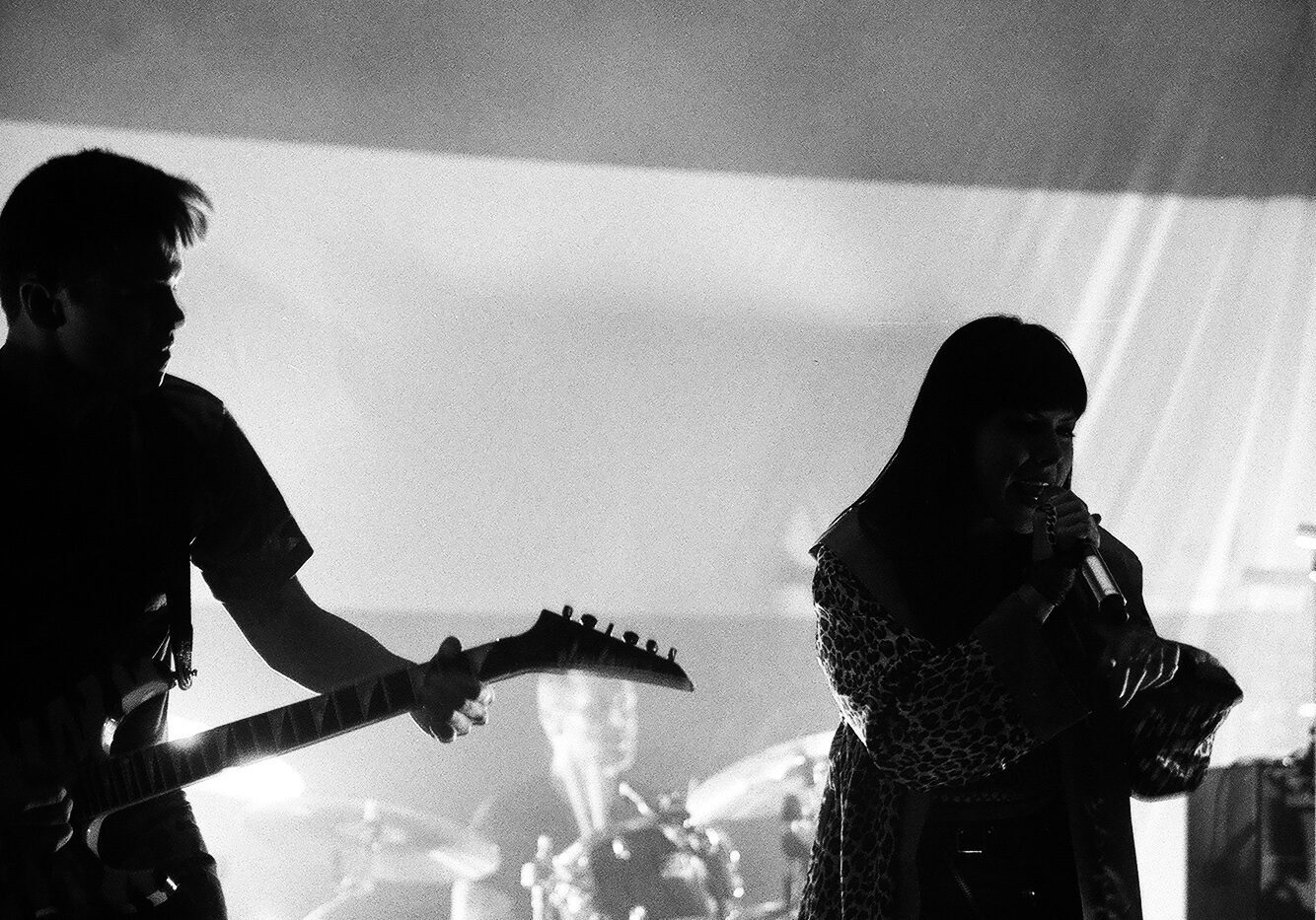 Band performing on stage in black and white.