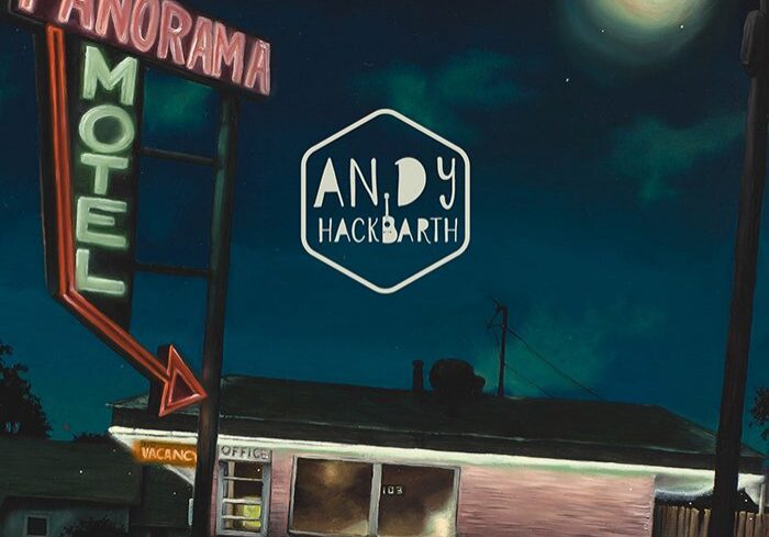 Nighttime motel scene with neon signs.