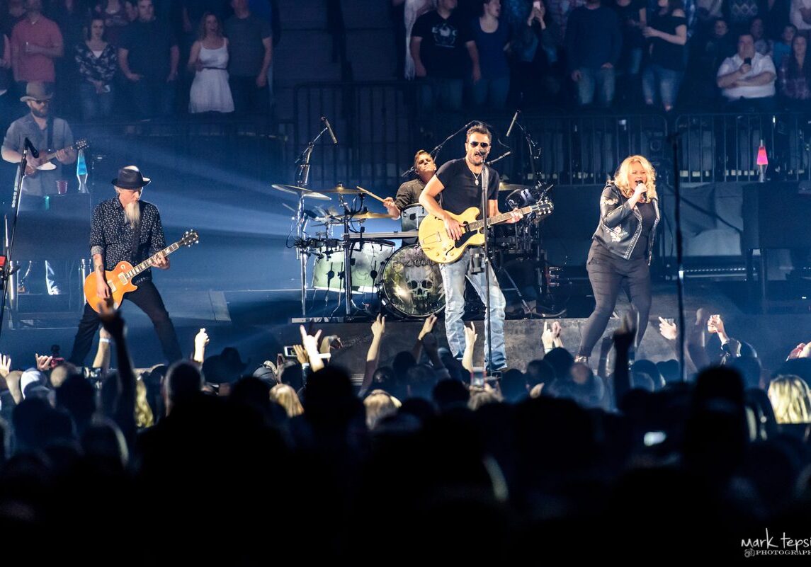 Band performing live on stage at concert.