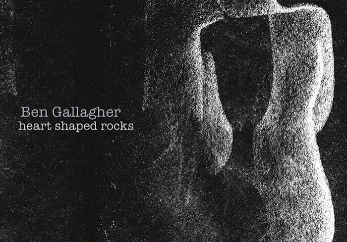 Abstract heart-shaped rocks on textured background.