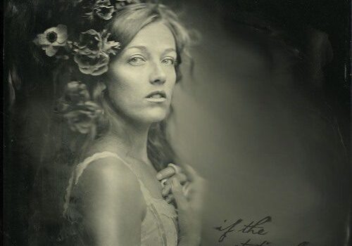Woman with flowers in sepia-toned portrait.