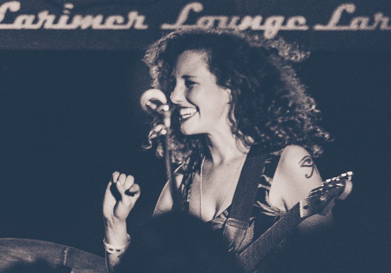 Smiling musician performing at a concert.