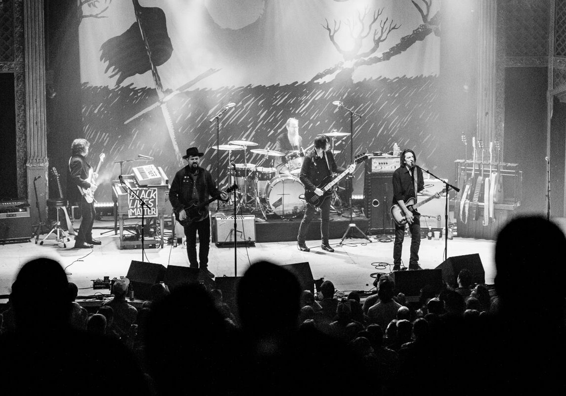 Black and white rock band concert performance.