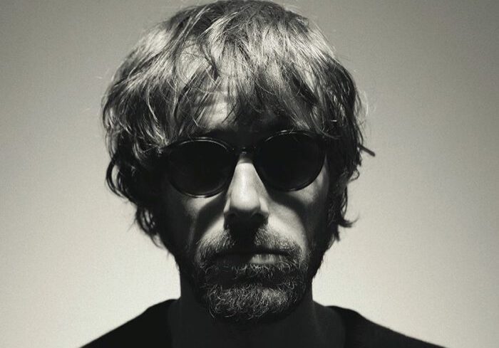 Man with sunglasses in dramatic lighting.
