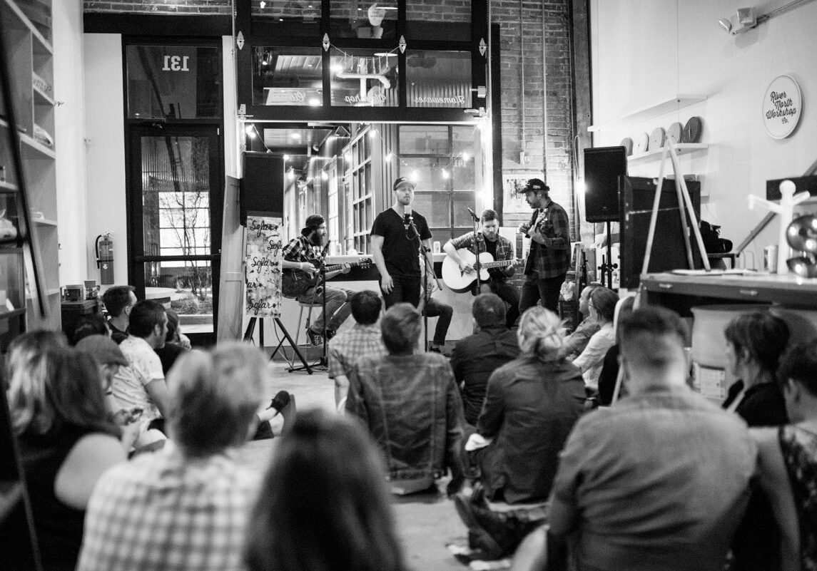 People enjoying live acoustic music performance indoors.