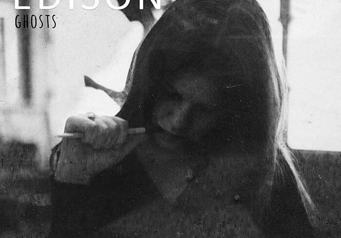 Woman writing in dimly lit room.