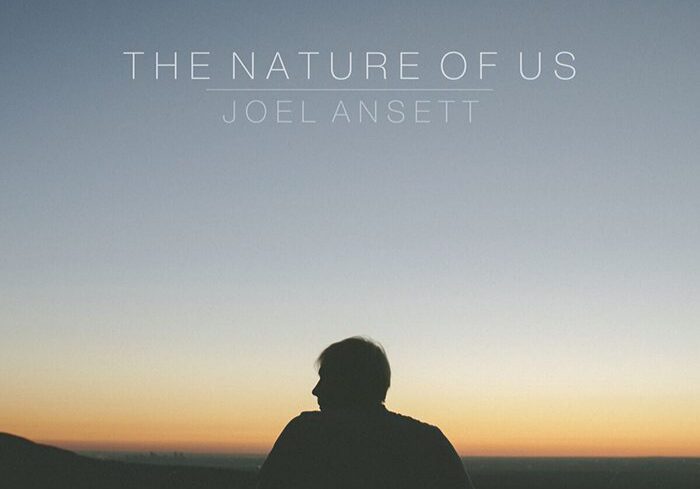 Silhouette of person against sunset sky.