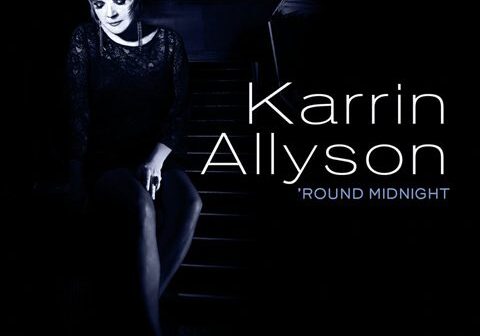 Singer sitting on stairs, album cover.