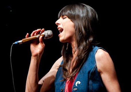 Singer performing passionately with a microphone.