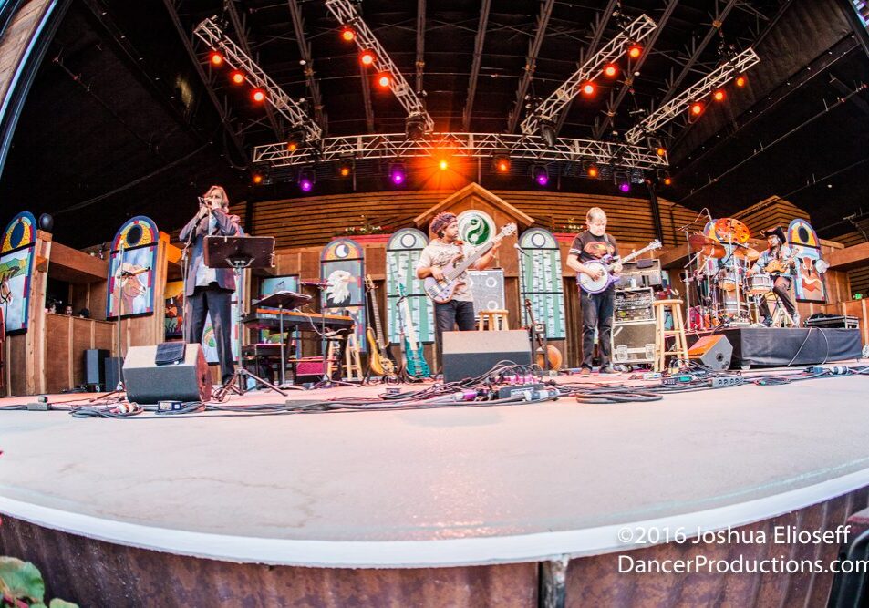 Band performing on an outdoor stage.