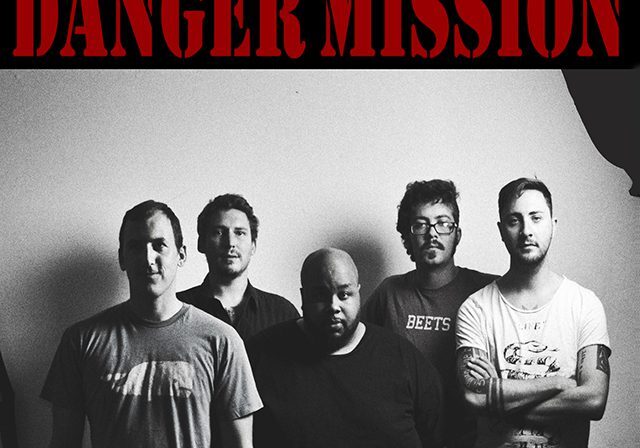 Band members posing in black and white.